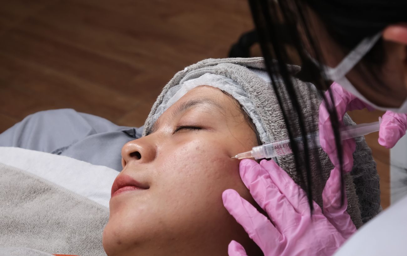 A provider performing a facial aesthetic treatment